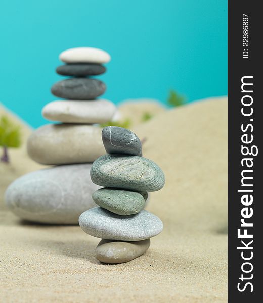 Zen rocks towers, in a sea shore miniature landscape, with water reflexion. Zen rocks towers, in a sea shore miniature landscape, with water reflexion