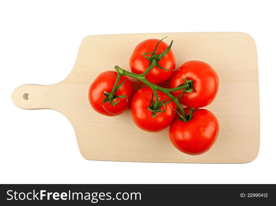 Cutting board with a branch of tomatoes isolated on white