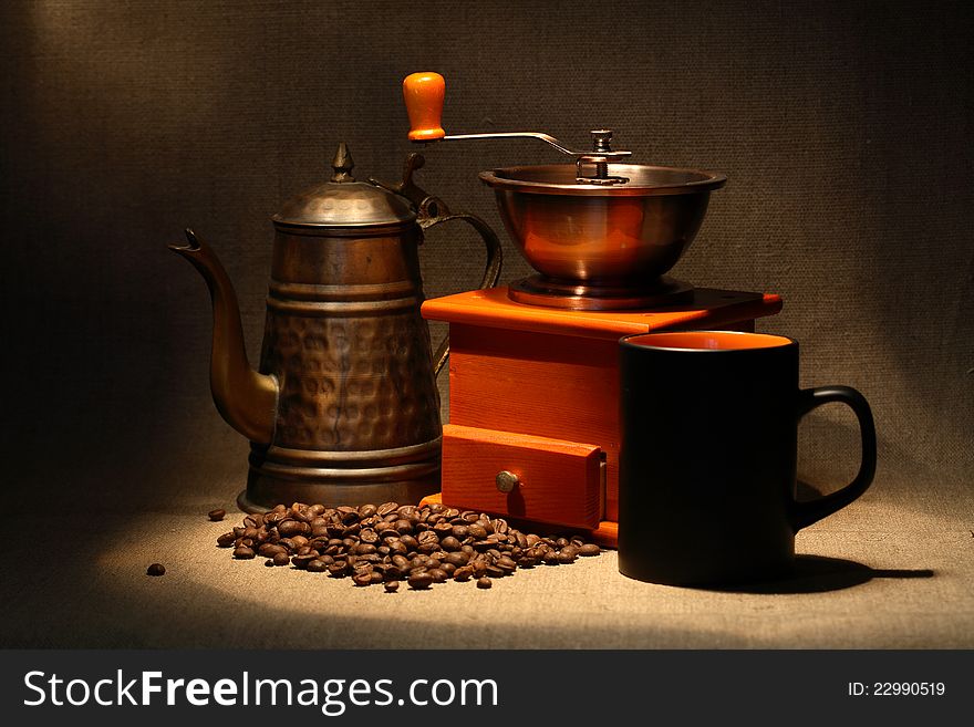 Nice vintage manual coffee grinder and coffeepot near beans on canvas background. Nice vintage manual coffee grinder and coffeepot near beans on canvas background
