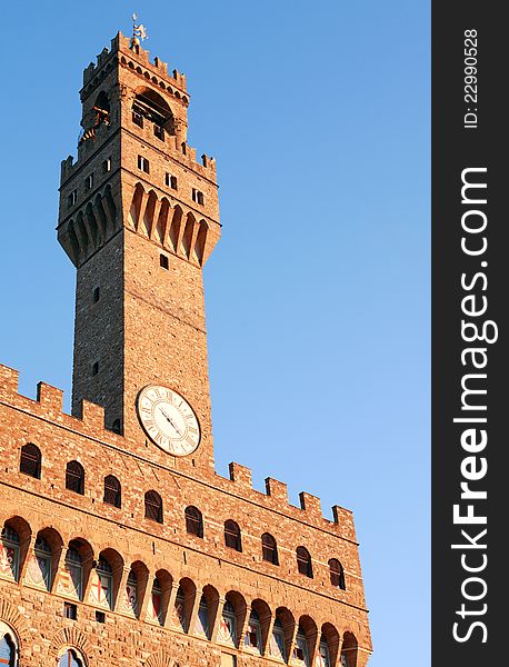 Closeup of Palazzo Vecchio tower against blue sky. Florence, Italy. Closeup of Palazzo Vecchio tower against blue sky. Florence, Italy