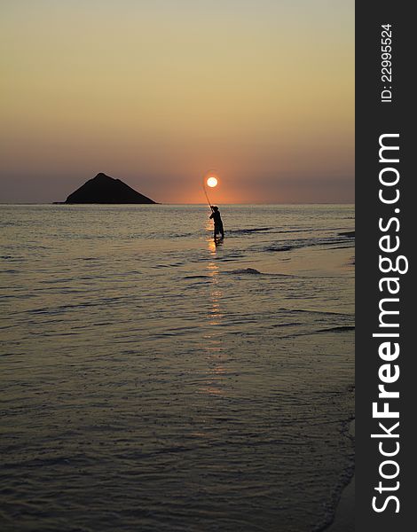 Fisherman at sunrise in hawaii