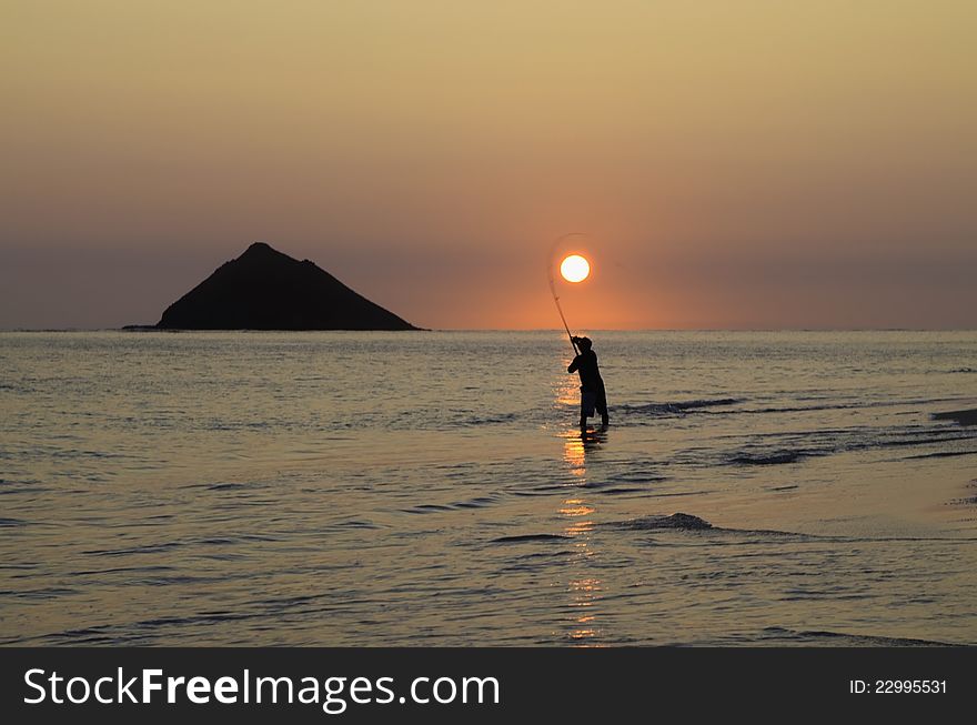 Fisherman at sunrise in hawaii