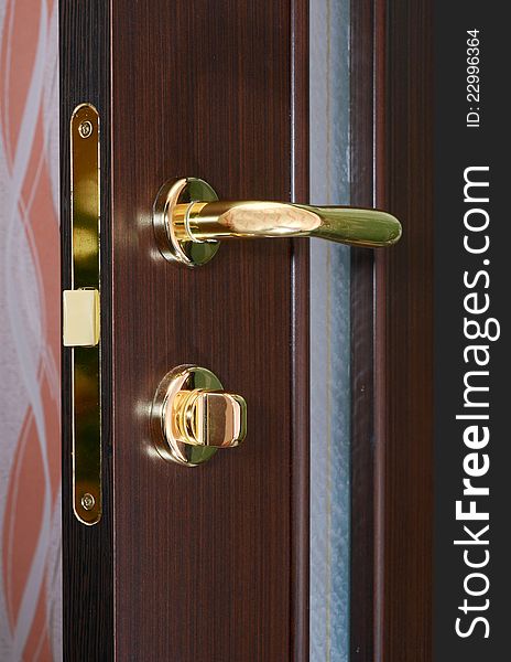 Chrome handle on wooden door. Chrome handle on wooden door