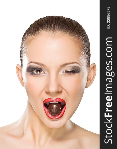 Beautiful young woman eating chocolates
