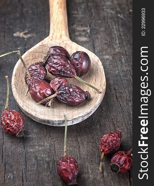 Close up of dog rose on wooden plank