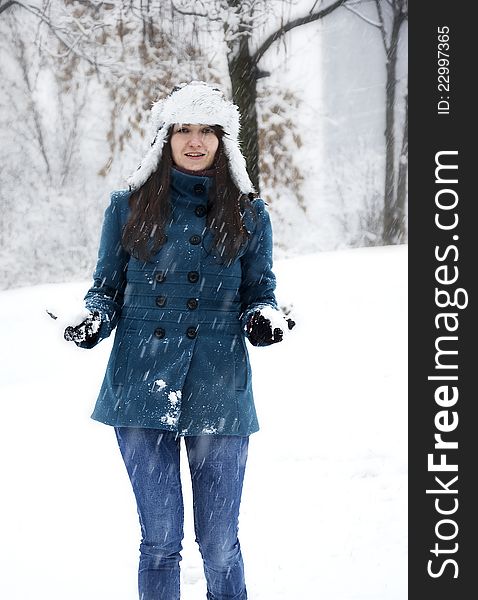 Young woman playing with snow