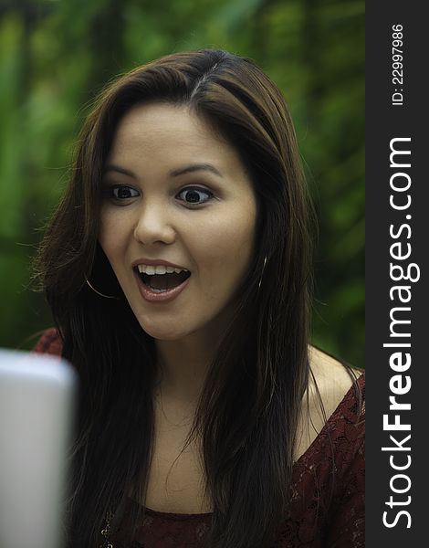 Portrait of a beautiful young woman with her laptop outdoors