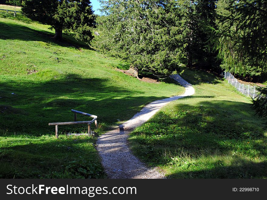 White pebbles path in green mountain landscape