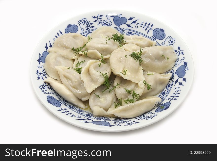 Dish with cooked dumplings on a white background. Dish with cooked dumplings on a white background