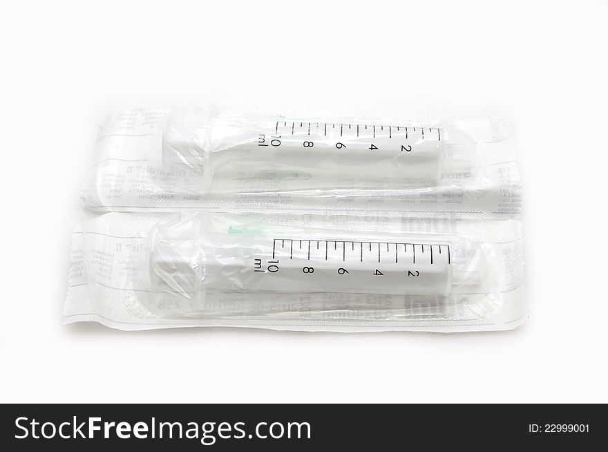 Two syringes in a package on a white background. Two syringes in a package on a white background