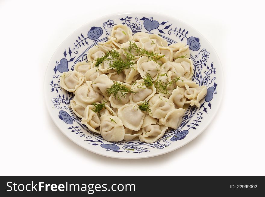 Large plate of cooking dumplings on a white background. Large plate of cooking dumplings on a white background
