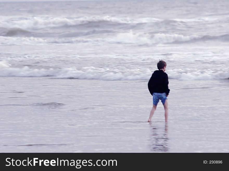 Boy Walking In The Sea