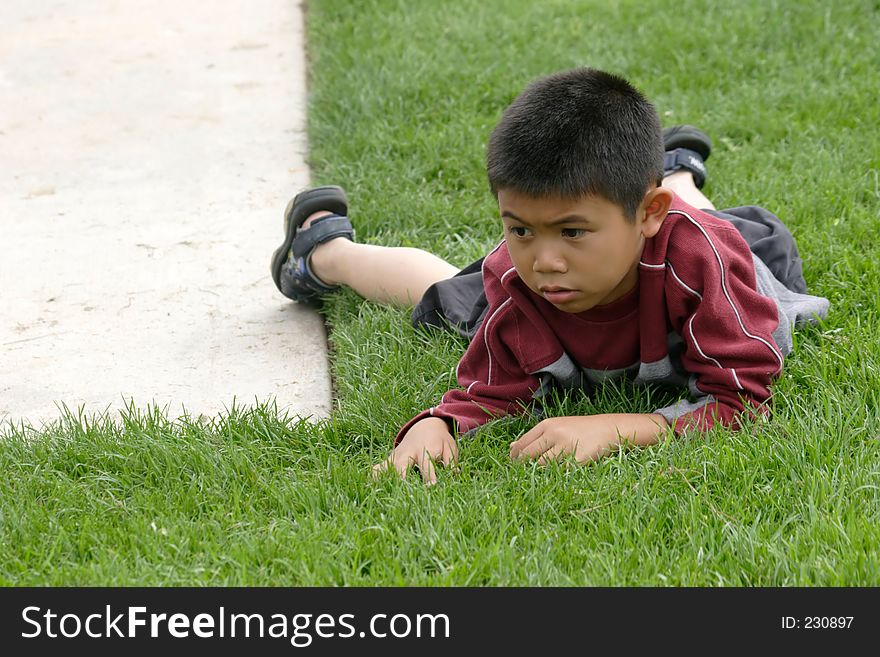 Boy resting on the grass