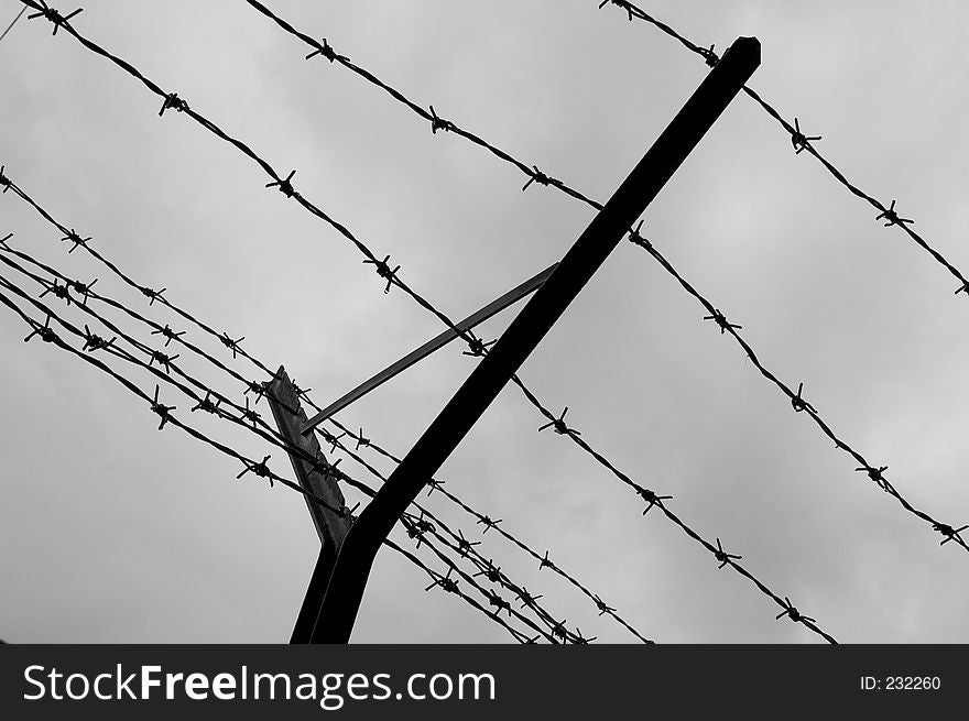 Looking up at double barbed wire fence