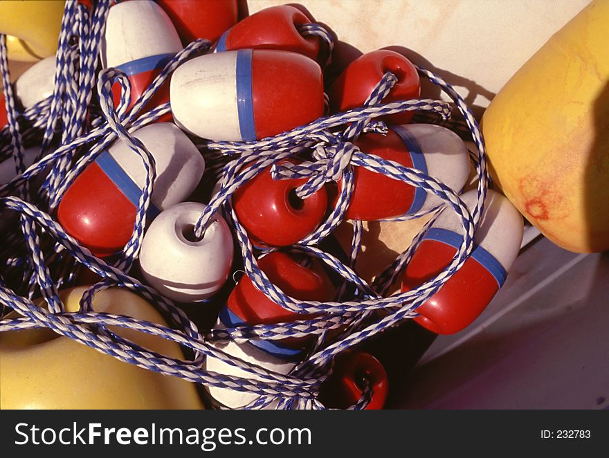 Yellow red white and blue buoys on the ropes. Yellow red white and blue buoys on the ropes