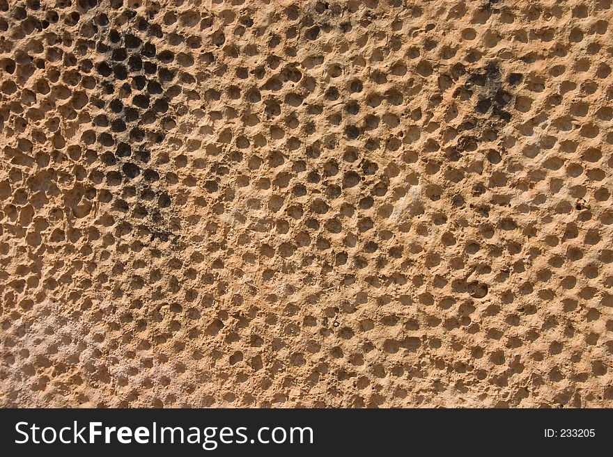 A pattern engraved in rock at close up. Suitable for backgrounds. Rock was found in a historic park dated around 3000 B.C. A pattern engraved in rock at close up. Suitable for backgrounds. Rock was found in a historic park dated around 3000 B.C.