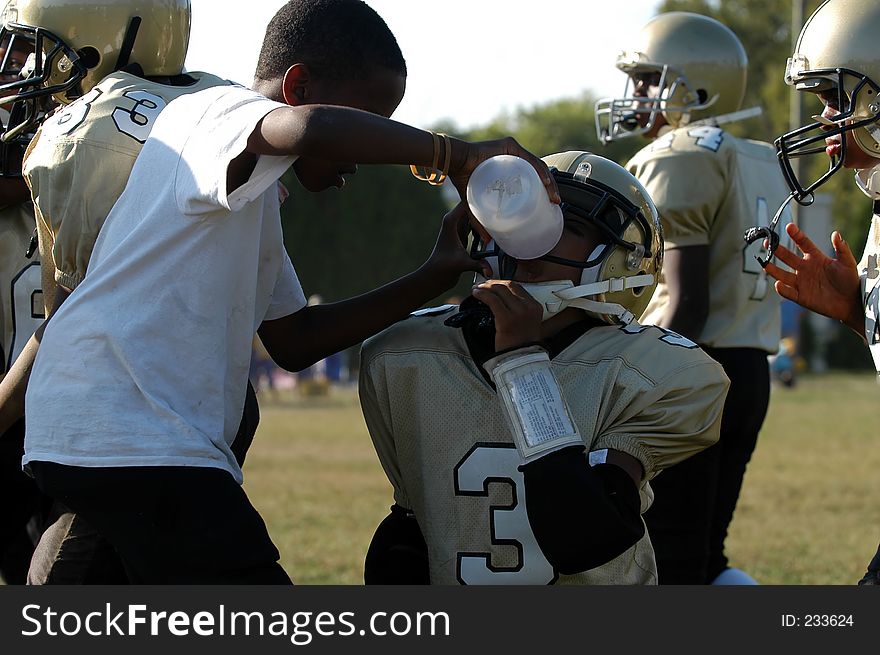 Acting water boy gives a player water