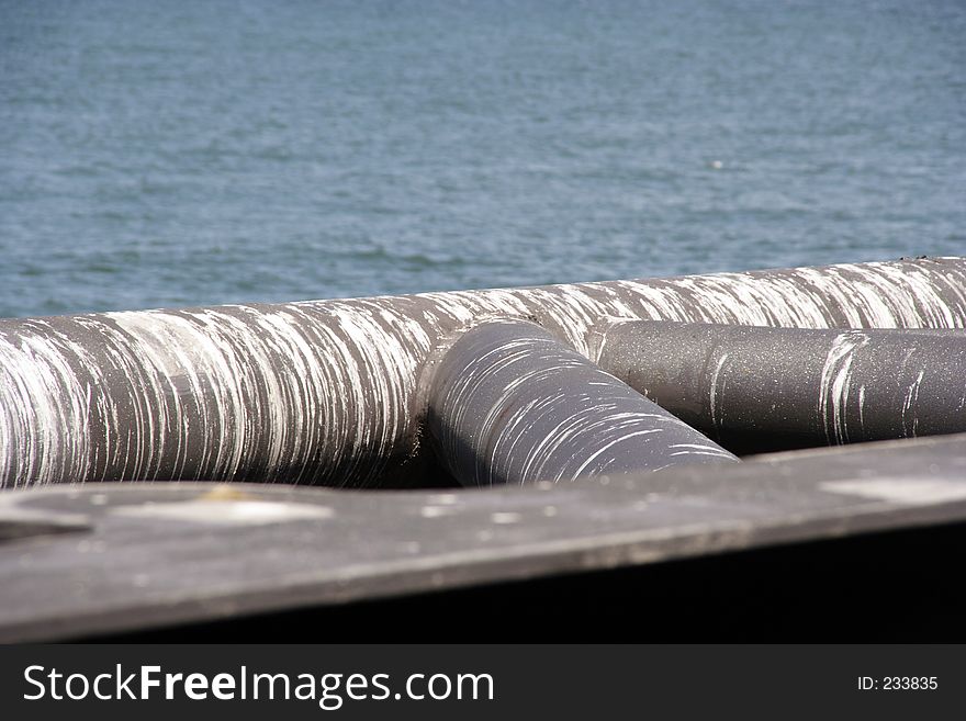 Dirty pipes, on the sea-shore, covered with gull-poop