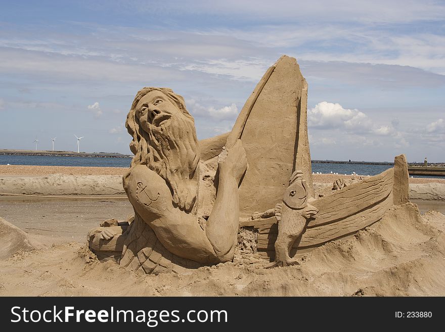 A sailor in his boat made of sand. A sailor in his boat made of sand