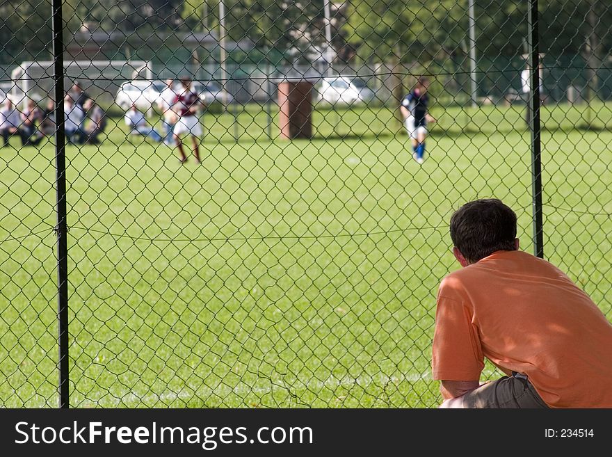 A father assisting to his son football match. A father assisting to his son football match