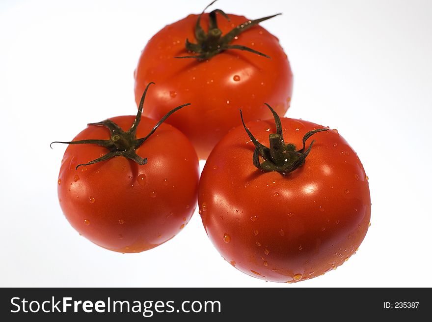 Red, ripe tomatoes with water droplets
