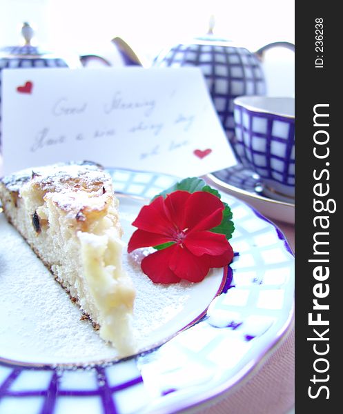 With love served breakfast. Cup of tea with a piece of cake decorated with postcard: Good morning! Have a nice day! With love. With love served breakfast. Cup of tea with a piece of cake decorated with postcard: Good morning! Have a nice day! With love