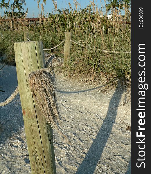 Fence post on beach path to motel