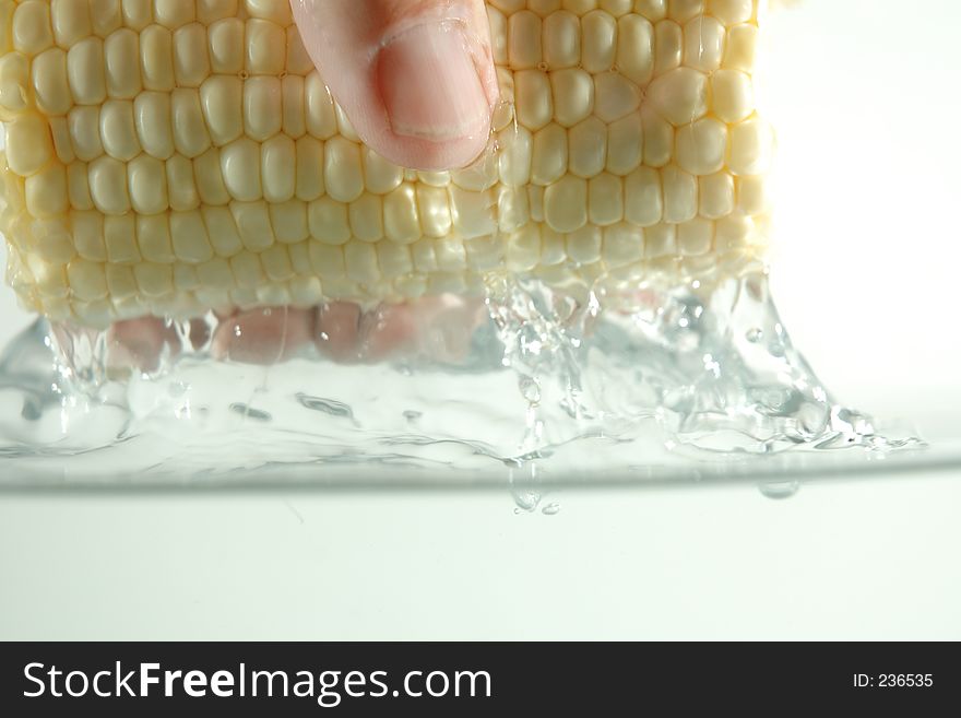 Corn and hand in water