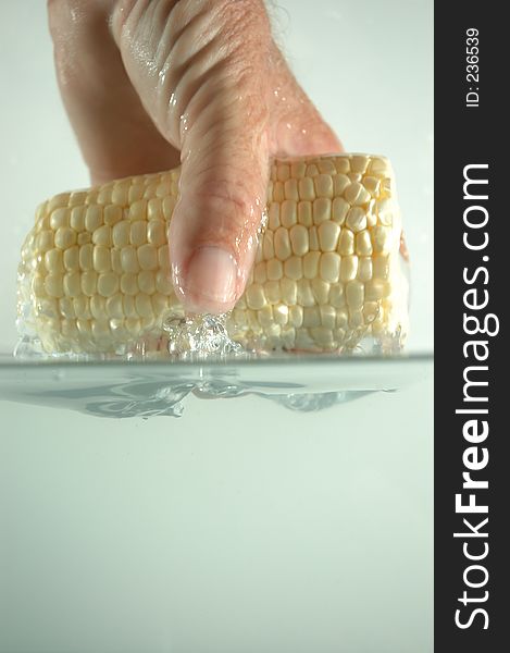 Hand and corn in water 2