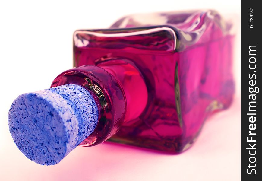 Glass bottle containg pink fluid. Glass bottle containg pink fluid