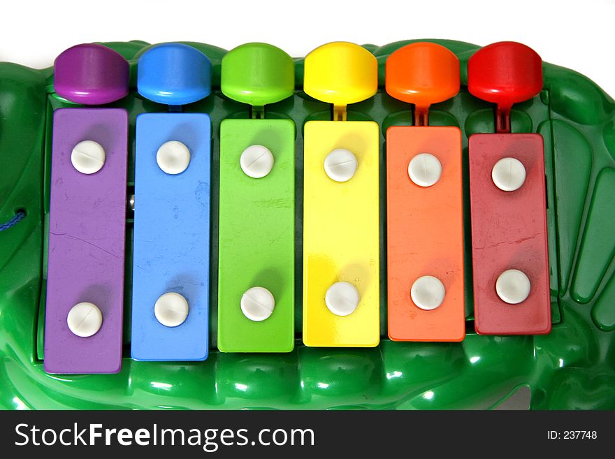 Multi colored children's xylophone in the shape of a friendly alligator. Multi colored children's xylophone in the shape of a friendly alligator