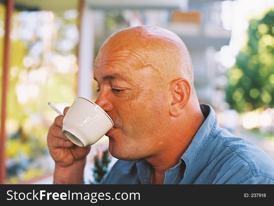 Bald Head Enjoying Coffee And Cigarette