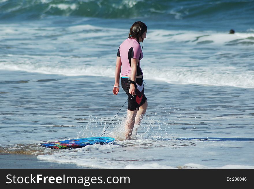 Young girl on beach with her body board. Young girl on beach with her body board