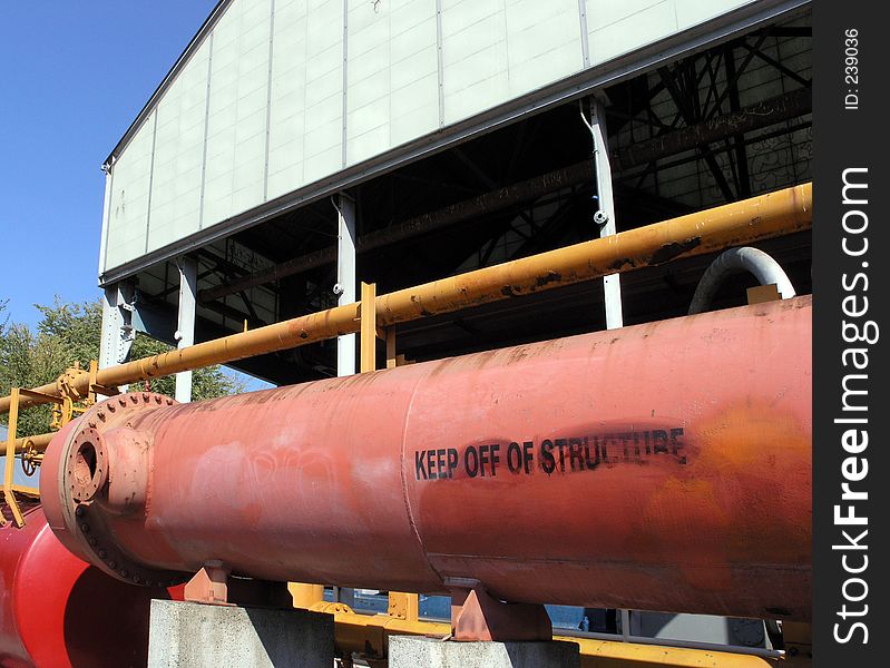 Keep off of Structure is stenciled on this thick pipe at Seattle's Gasworks Park. The park used to be a manufacturing facility that converted coal and oil to gas. It was closed in 1956, and later bought by the city and turned into a park.