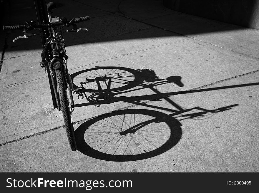 Old bicycle on the street of New York with its shadow. Old bicycle on the street of New York with its shadow