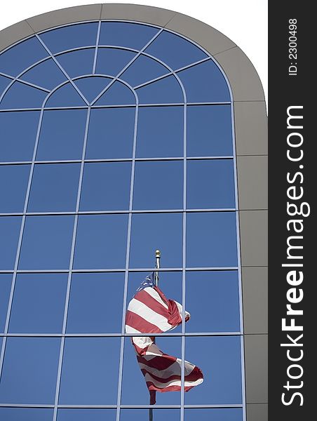 The reflection of an american flag in the windows. The reflection of an american flag in the windows