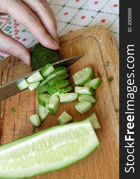 Cutting of cucumberon wooden a plate
