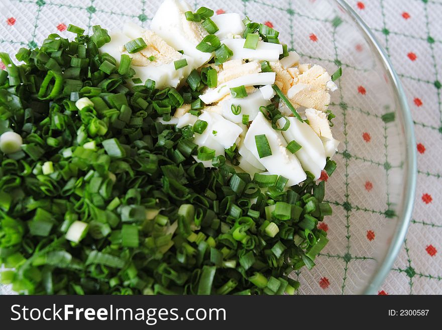 Salad with eggs in a glass plate