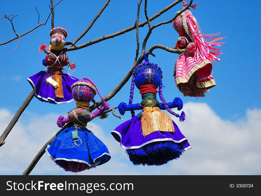 Ukrainian ethnic handmade dolls on the branch. Ukrainian ethnic handmade dolls on the branch