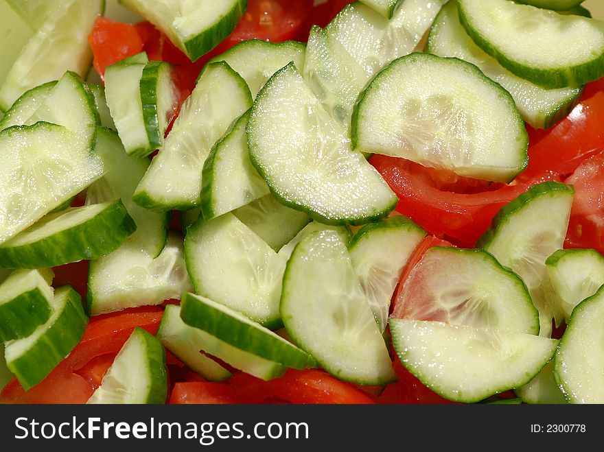 Unfinished cucumber-tomato salad, close-up.