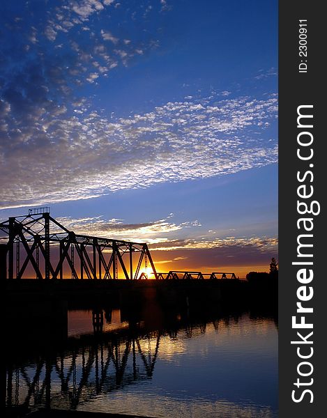 Trestle Bridge at Sunset over San Jaoquin River, Central Valley, California. Trestle Bridge at Sunset over San Jaoquin River, Central Valley, California