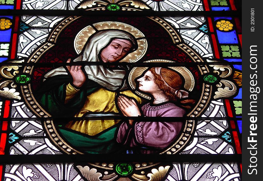 A view of a stained glass window in a French church.  It depicts Mother and Child. A view of a stained glass window in a French church.  It depicts Mother and Child.
