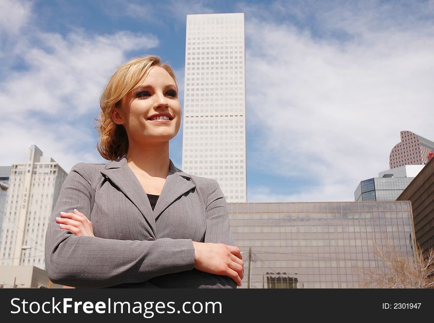 Business woman is posing in front of some business buildings. Business woman is posing in front of some business buildings