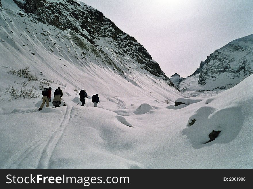 Sporting people going through the snow-covered Swiss Alps. Sporting people going through the snow-covered Swiss Alps