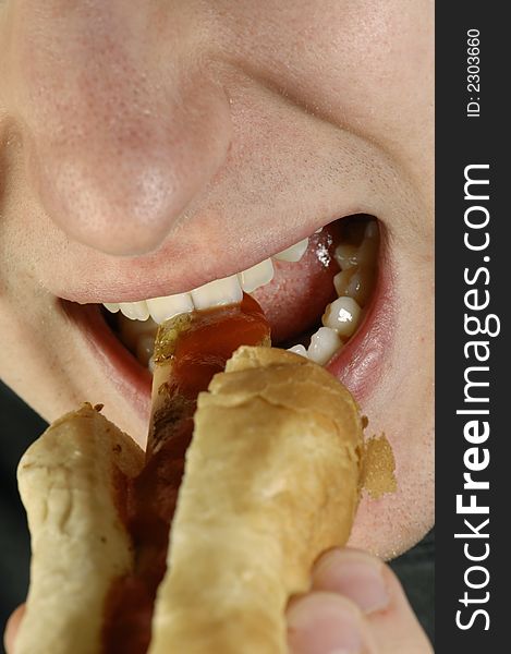 Greedy face, mouth eating a hot-dog, close-up idea. Greedy face, mouth eating a hot-dog, close-up idea
