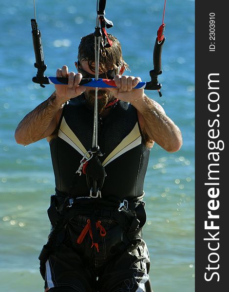 Kite surfer concentrating on his technique before launching. Kite surfer concentrating on his technique before launching