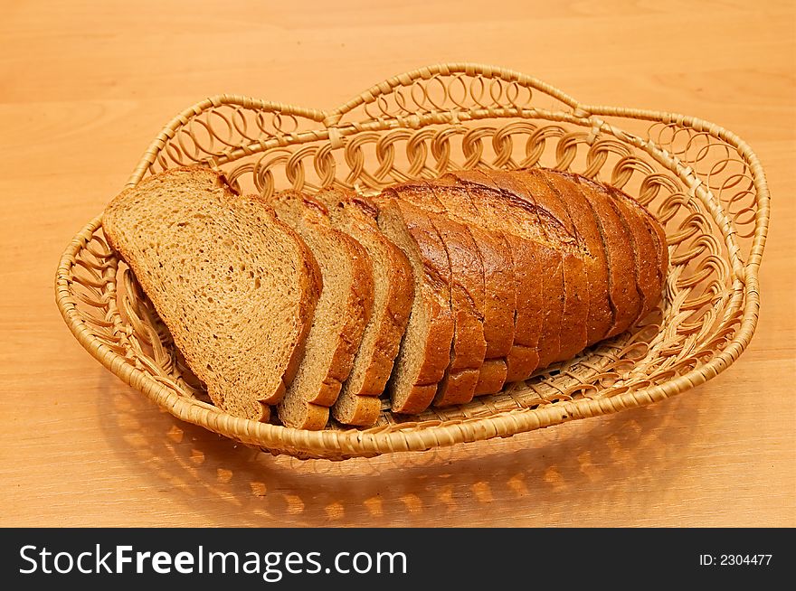 Cut loaf of rye bread on wum plate