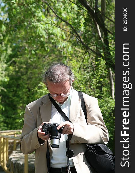 Photographer checking the settings of his digital camra.