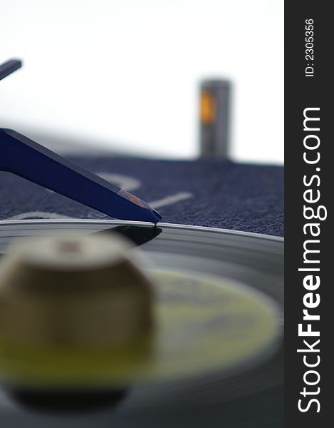 A blue needle on the vinyl record. A blue needle on the vinyl record