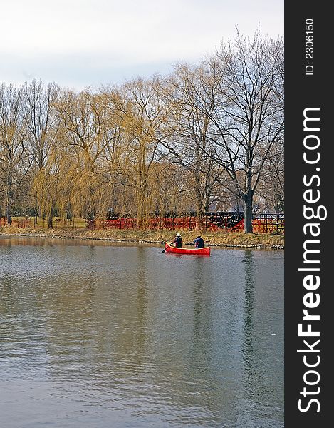 Two canoeists in a red canoe on a spring day at the Toronto (Ontario, Canada) Islands. Two canoeists in a red canoe on a spring day at the Toronto (Ontario, Canada) Islands.